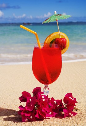 a-tropical-cocktail-on-the-beach-garnished-with-fruit-and-flowers