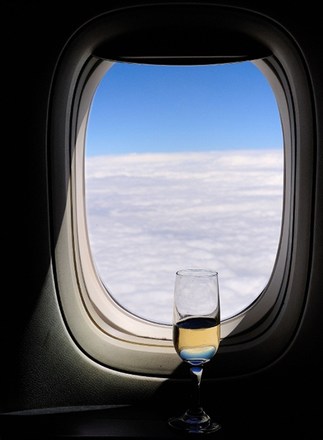 airplane-window-with-champagne-glass
